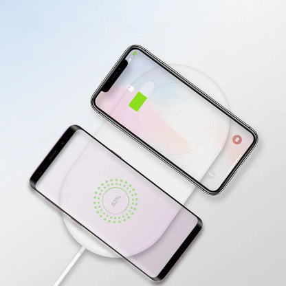 White dual phone wireless charging pad for simultaneous fast charging of two mobile phones