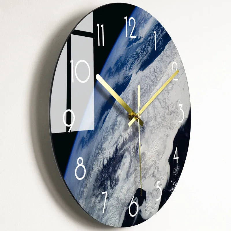 Round silent wall clock with acrylic glass dial, shown in a living room setting.
