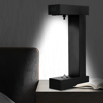 Obsidian black anti-gravity floating sand drop table lamp with geometric hourglass and LED glow
