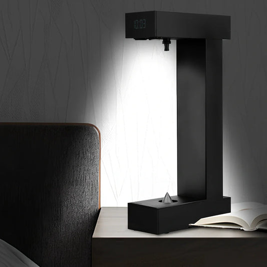 Obsidian black anti-gravity floating sand drop table lamp with geometric hourglass and LED glow