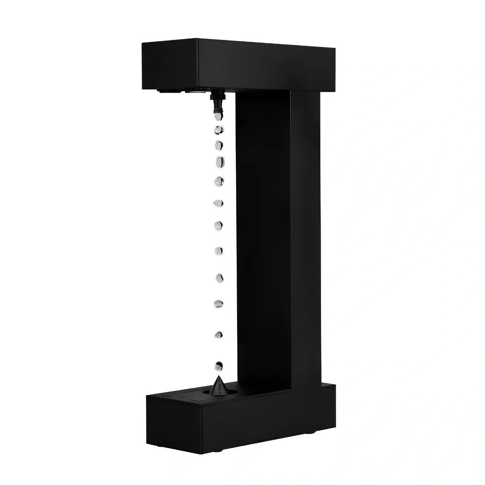 Obsidian black anti-gravity floating sand drop table lamp with geometric hourglass and LED glow