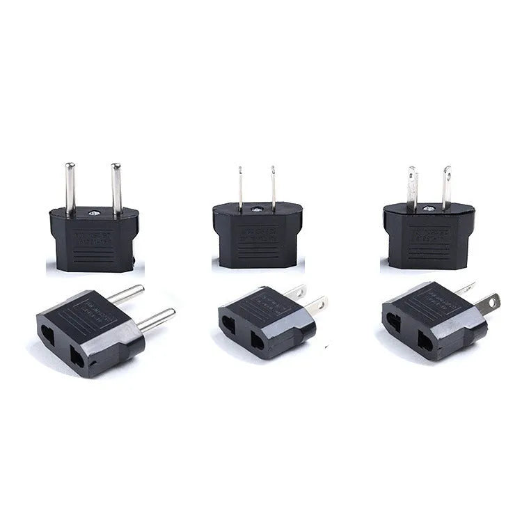Black and white travel power adapter with three AC sockets showing AU EU US plug options