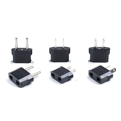 Black and white travel power adapter with three AC sockets showing AU EU US plug options