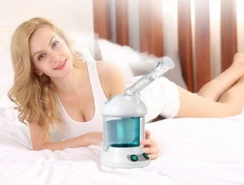 Facial steamer device with rotating nozzle and water tank for spa-like skin rejuvenation at home
