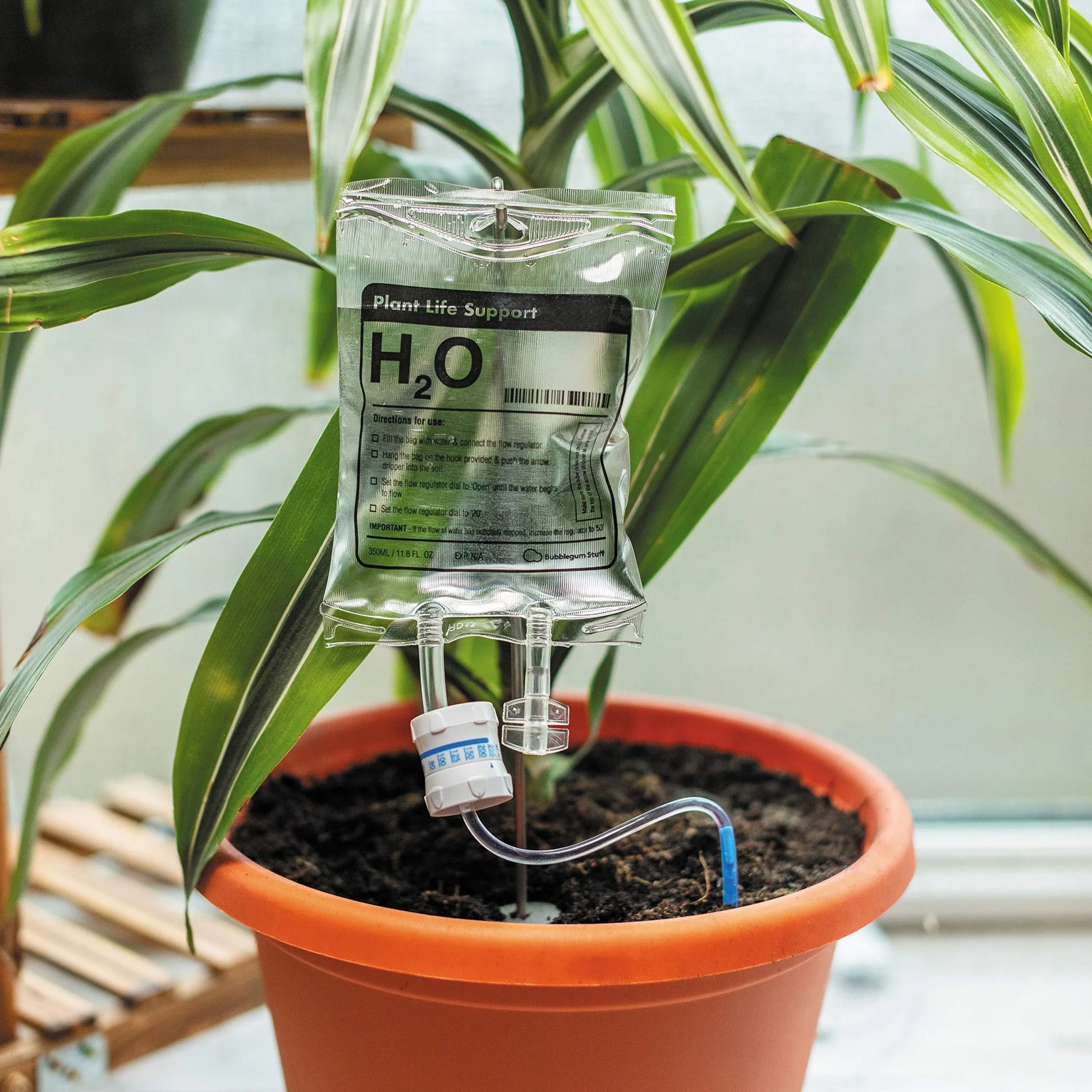 A transparent, self-watering plant feeder device with a 1000ml or 3000ml capacity, designed to keep indoor and outdoor plants hydrated for up to 7 days.