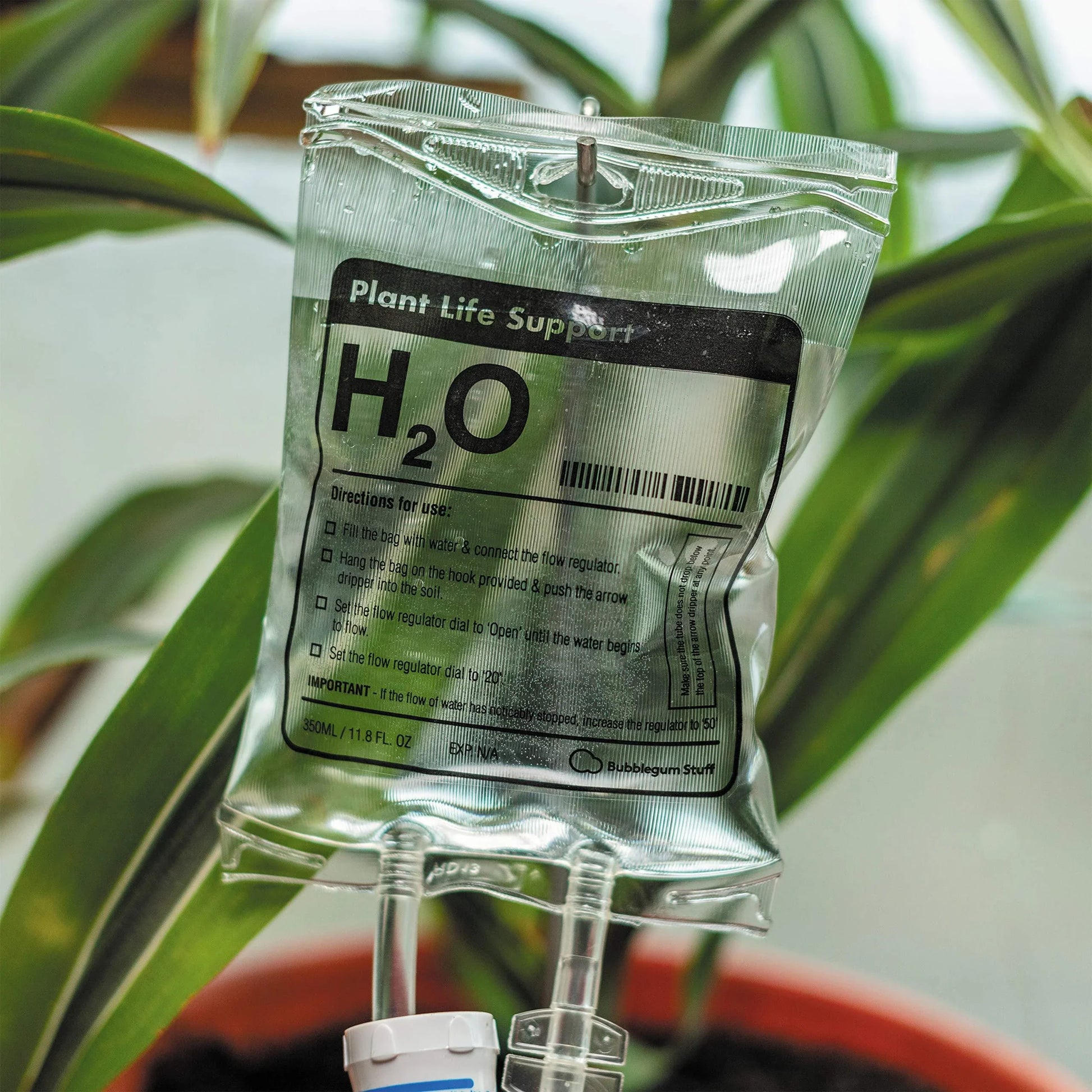 A transparent, self-watering plant feeder device with a 1000ml or 3000ml capacity, designed to keep indoor and outdoor plants hydrated for up to 7 days.