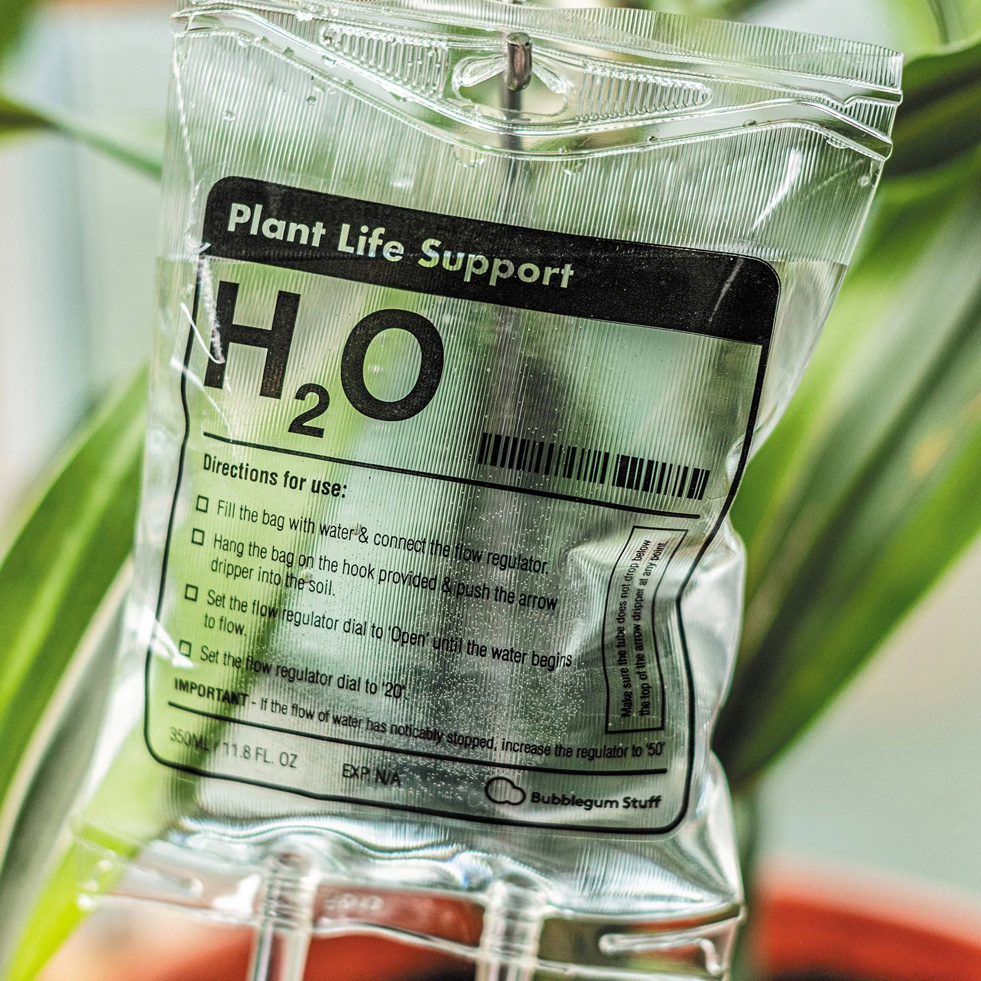 A transparent, self-watering plant feeder device with a 1000ml or 3000ml capacity, designed to keep indoor and outdoor plants hydrated for up to 7 days.