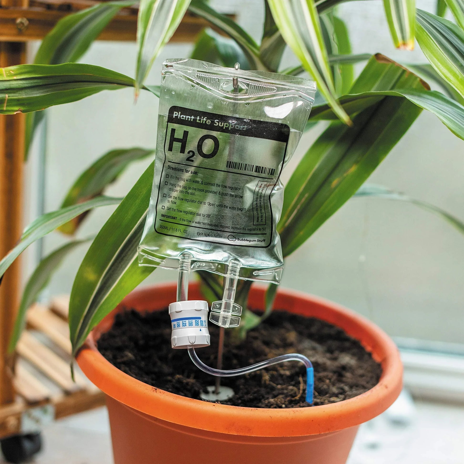 A transparent, self-watering plant feeder device with a 1000ml or 3000ml capacity, designed to keep indoor and outdoor plants hydrated for up to 7 days.