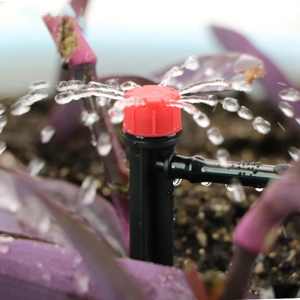 50-metre automatic garden irrigation system kit showing timer, tubing, and spray nozzles arranged for installation