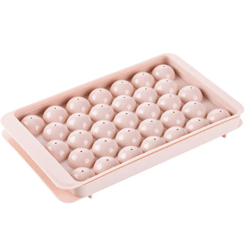 Sky blue and pink 3D round ice moulds creating spherical ice balls for drinks