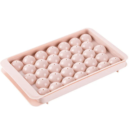 Sky blue and pink 3D round ice moulds creating spherical ice balls for drinks