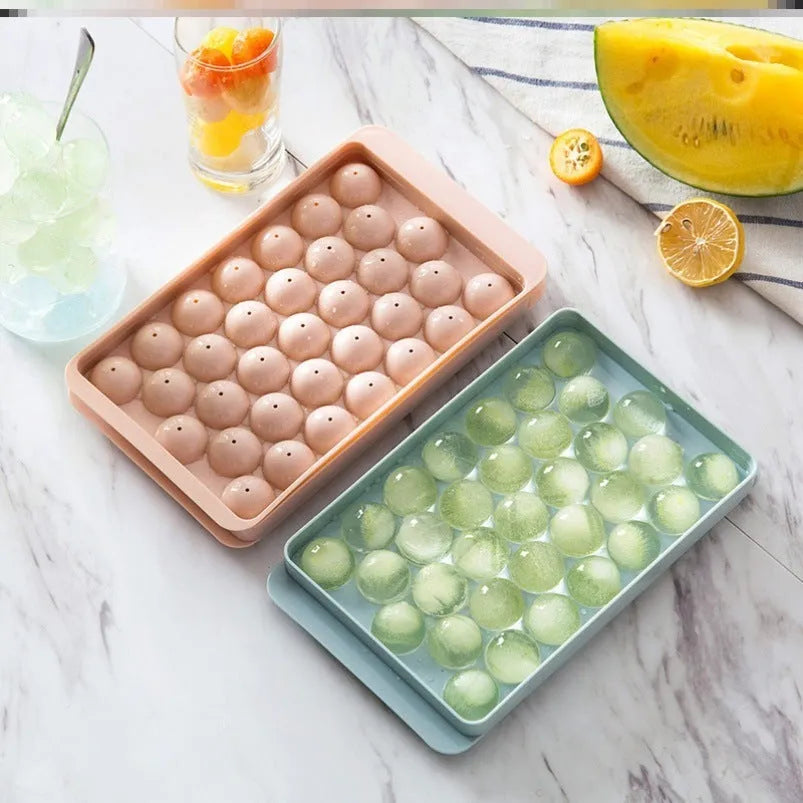 Sky blue and pink 3D round ice moulds creating spherical ice balls for drinks