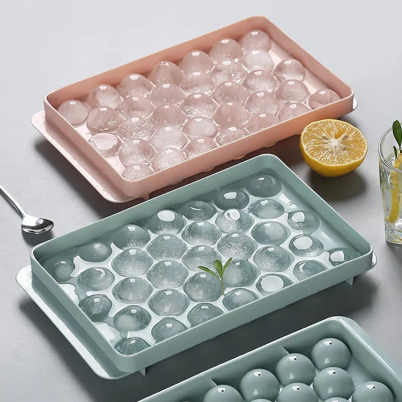 Sky blue and pink 3D round ice moulds creating spherical ice balls for drinks