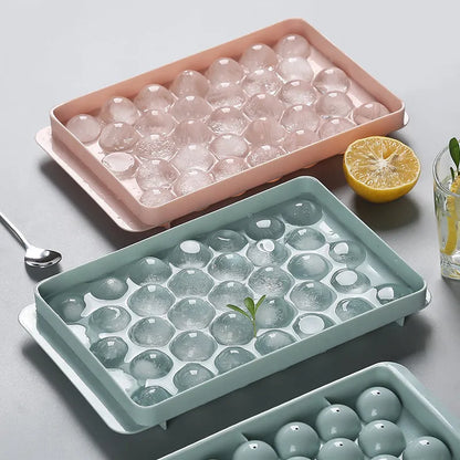 Sky blue and pink 3D round ice moulds creating spherical ice balls for drinks