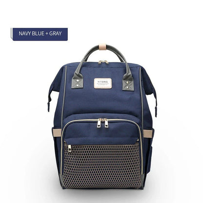Stylish maternity diaper bag in various colors, featuring a paper bag design, separate bottle compartment, and discreet breastfeeding button.