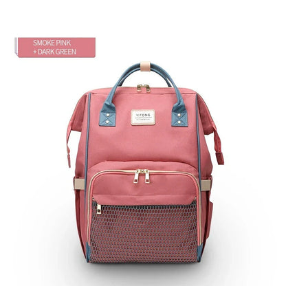Stylish maternity diaper bag in various colors, featuring a paper bag design, separate bottle compartment, and discreet breastfeeding button.