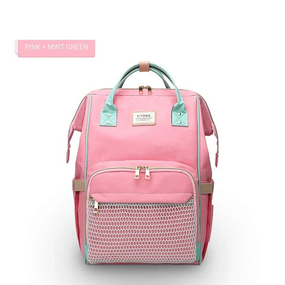 Stylish maternity diaper bag in various colors, featuring a paper bag design, separate bottle compartment, and discreet breastfeeding button.
