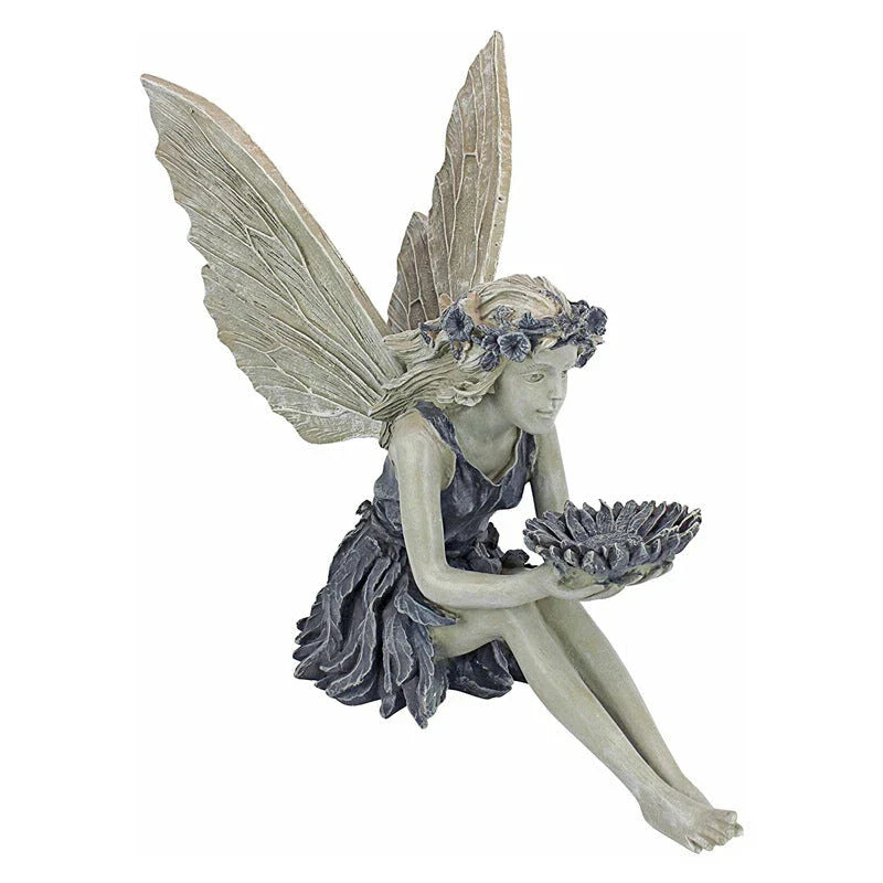 Beautifully detailed fairy statue with flower crown and petal skirt, holding a sunflower bowl in a garden setting