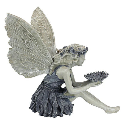Beautifully detailed fairy statue with flower crown and petal skirt, holding a sunflower bowl in a garden setting