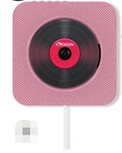 Wall-mounted tray-loading CD player in white colour with remote control on a wooden wall.