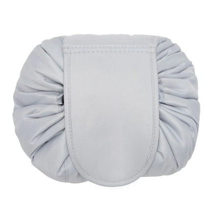 Stylish and roomy makeup travel bag with multiple color options, featuring a spacious interior and drawstring closure for secure storage of beauty essentials.