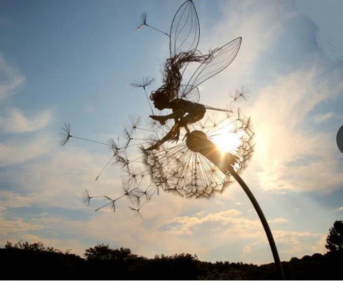 Enchanting fairy garden sculptures made of metal, featuring playful designs of fairies and pixies among dandelions and flowers.