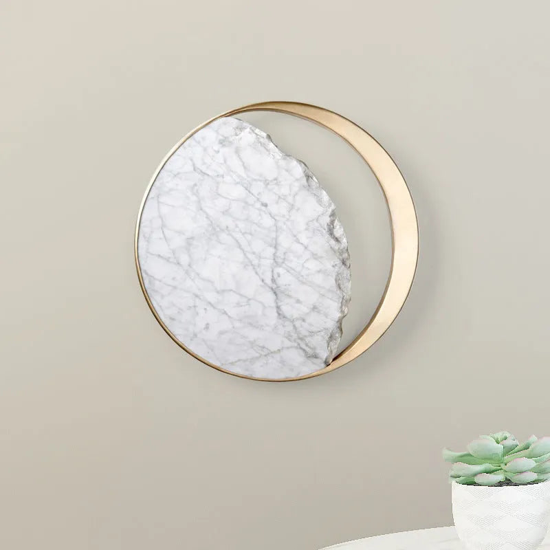 Round white marble and copper wall sconce LED light mounted on a wall