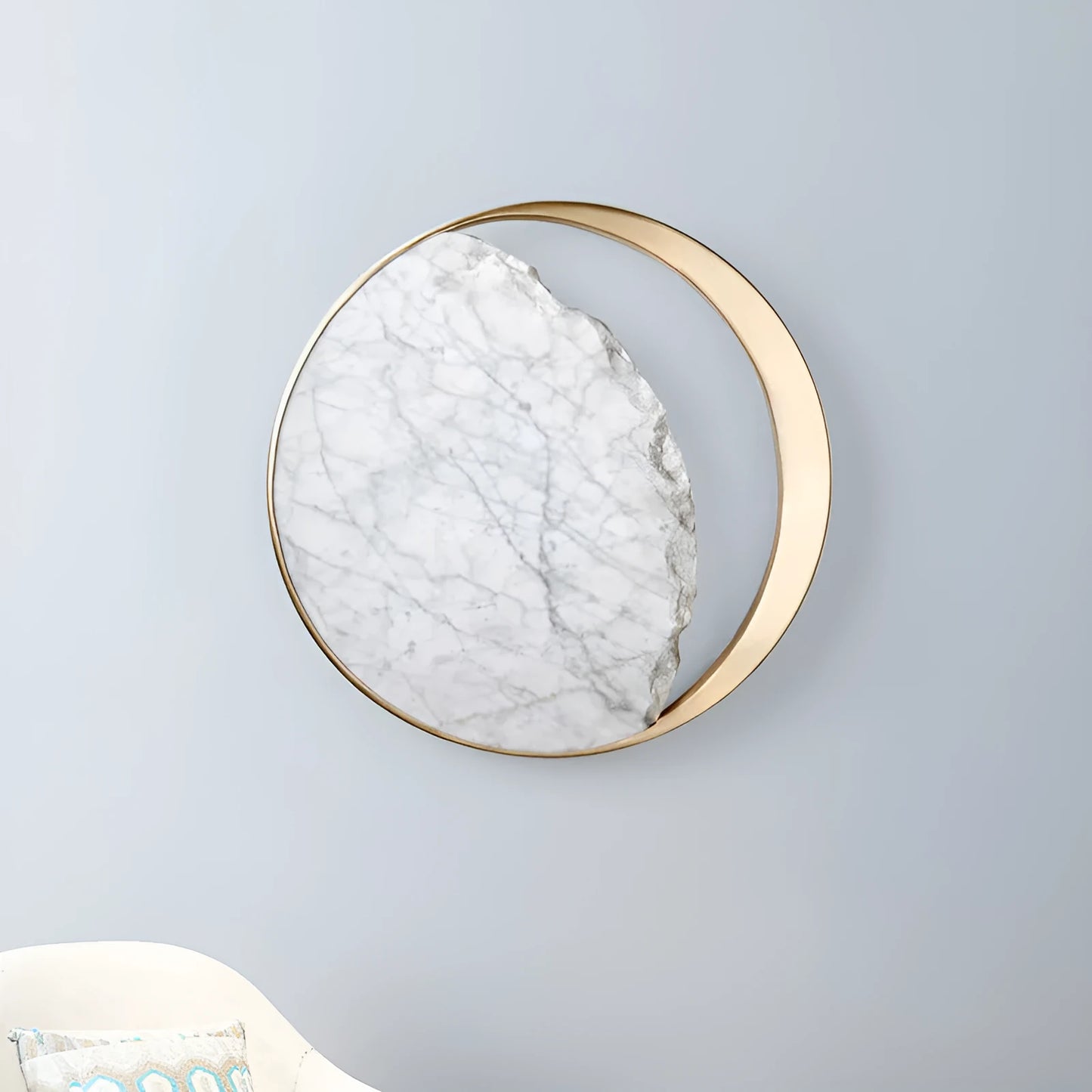 Round white marble and copper wall sconce LED light mounted on a wall