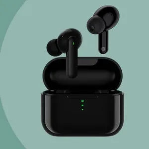 Black or white wireless Bluetooth in-ear headphones with a magnetic charging case on a table.