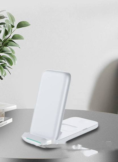 Black and white foldable 3-in-1 wireless charger showing three devices charging simultaneously
