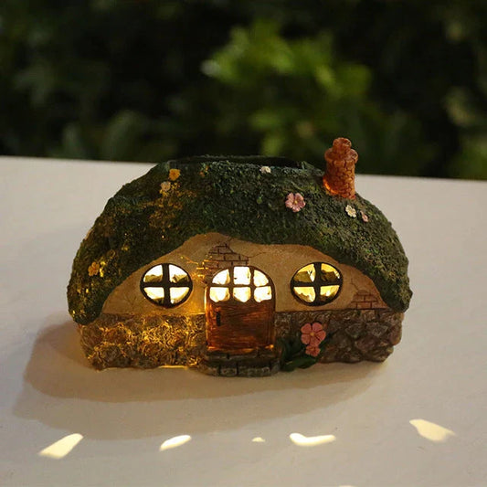 Solar-powered fairy house lamp with warm LED lighting for outdoor garden and patio decor