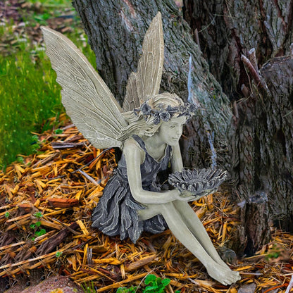 Beautifully detailed fairy statue with flower crown and petal skirt, holding a sunflower bowl in a garden setting
