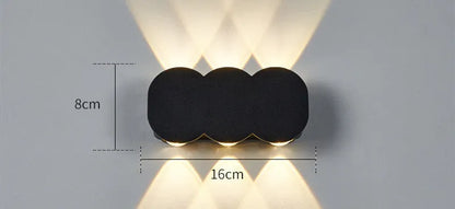 Modern square minimalist waterproof LED wall light mounted on an exterior wall.