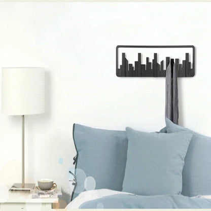 Wall-mounted coat rack with five flip-down hooks for organizing coats, hats, and other accessories
