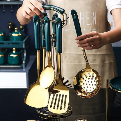 Seven-piece stainless steel and grey silicone kitchen utensil set including spatula, ladle, and serving spoon.