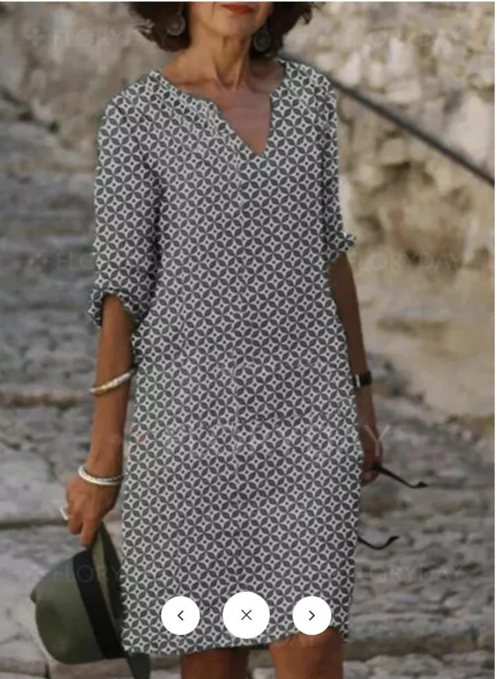 Vibrant mid-length dress with a colorful pattern, featuring a range of sizes and color options.