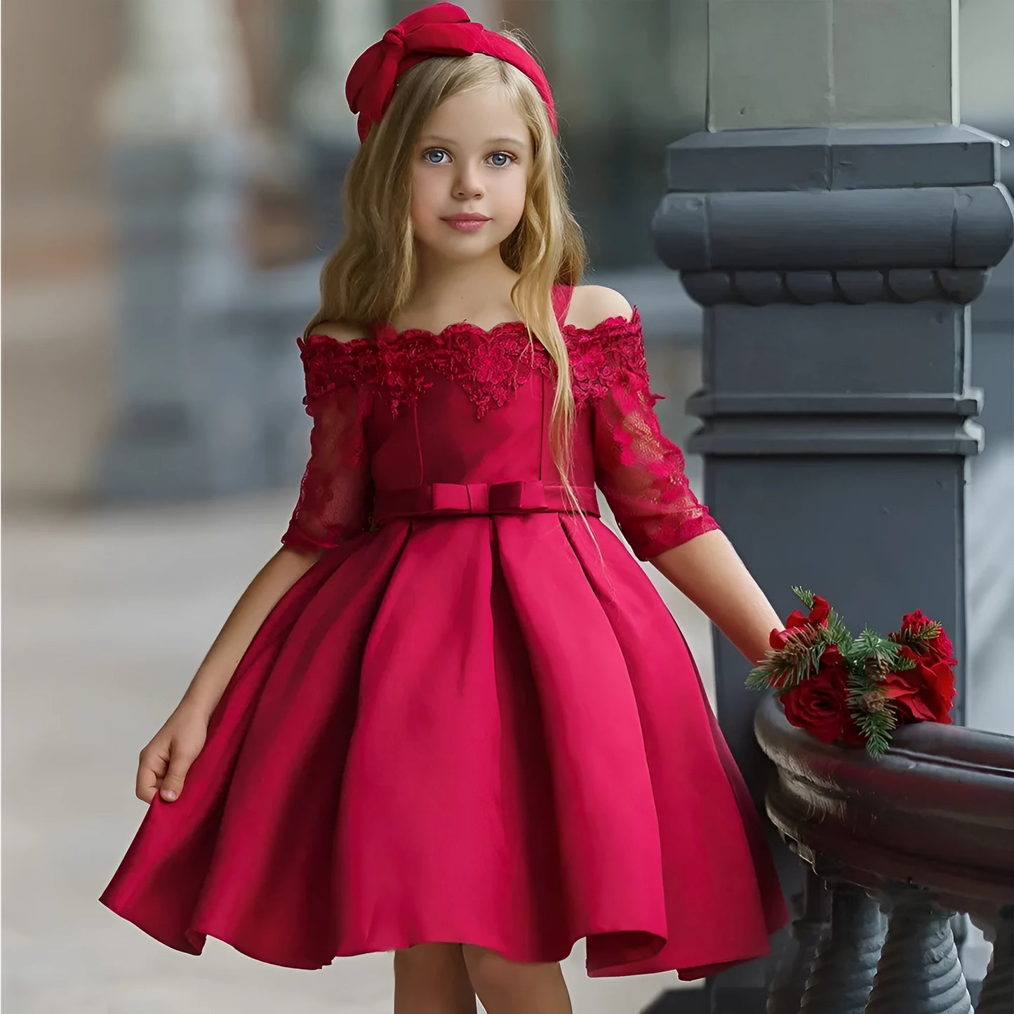 Simple children's polyester dress with lace trim in dark red, shown on a hanger.