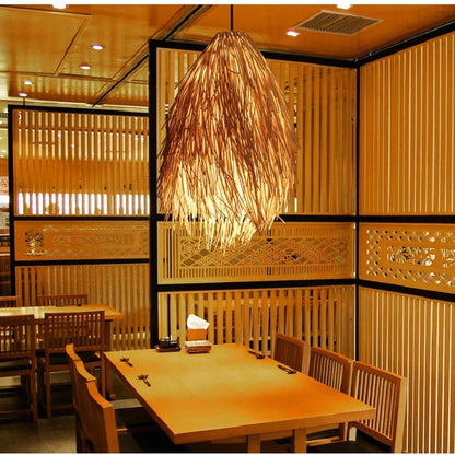 Rattan chandelier with pine cone decorative elements hanging on adjustable fishing line