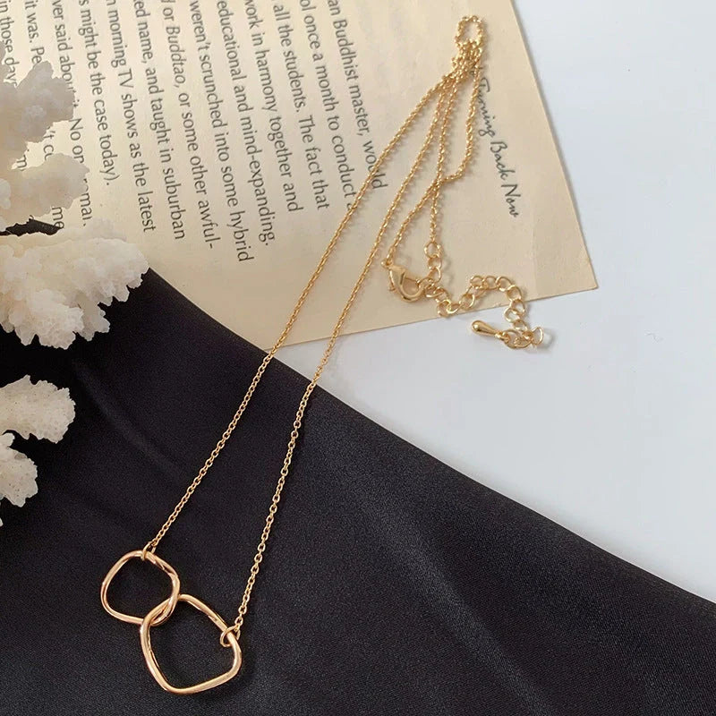 Gold alloy abstract face choker necklace with geometric pendant, adjustable length