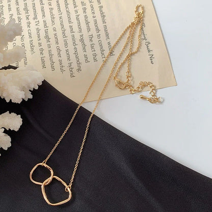 Gold alloy abstract face choker necklace with geometric pendant, adjustable length