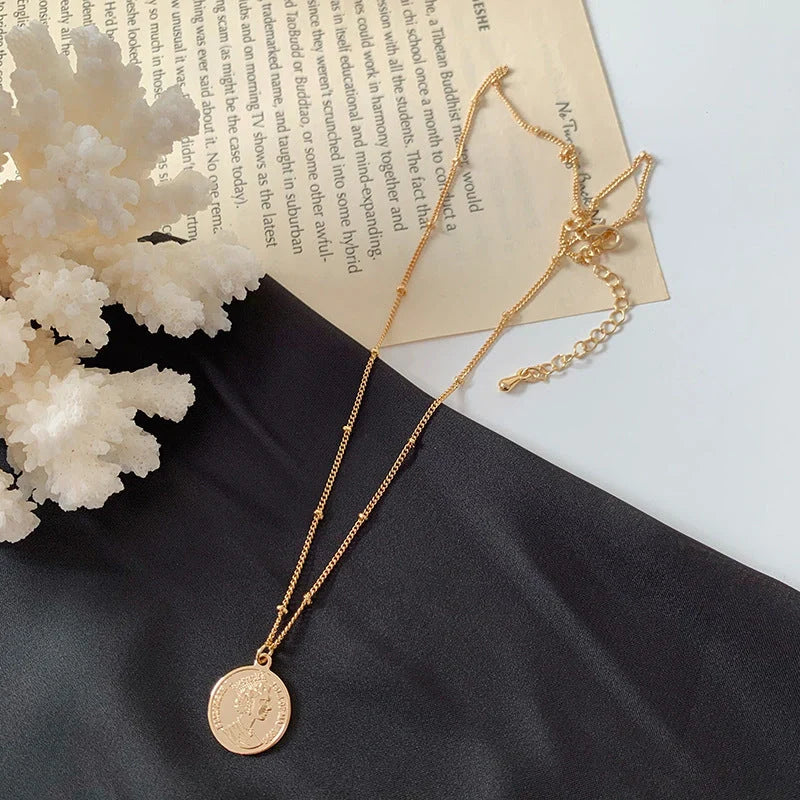 Gold alloy abstract face choker necklace with geometric pendant, adjustable length