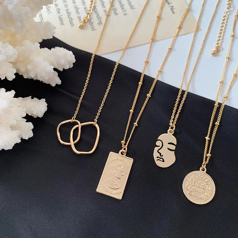 Gold alloy abstract face choker necklace with geometric pendant, adjustable length