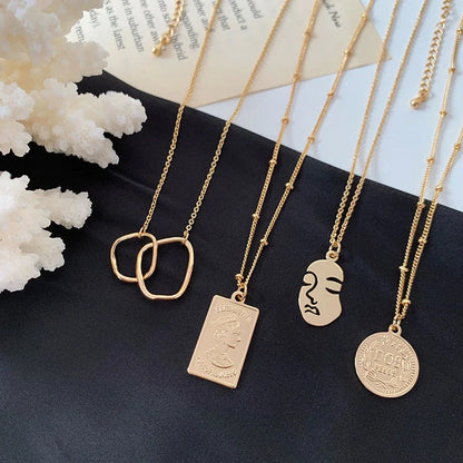 Gold alloy abstract face choker necklace with geometric pendant, adjustable length