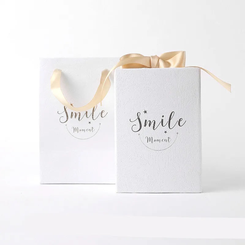 Small cardboard gift box with gold foil accents in blue, pink, red, or white with matching handbag and raffia
