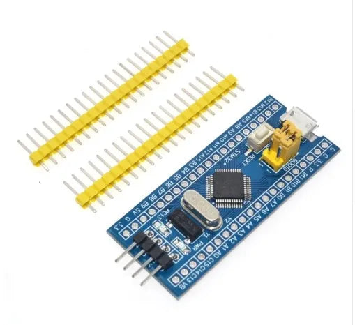 STM32F103C8T6 minimum system development board with blue PCB, Mini USB port, and pin headers.