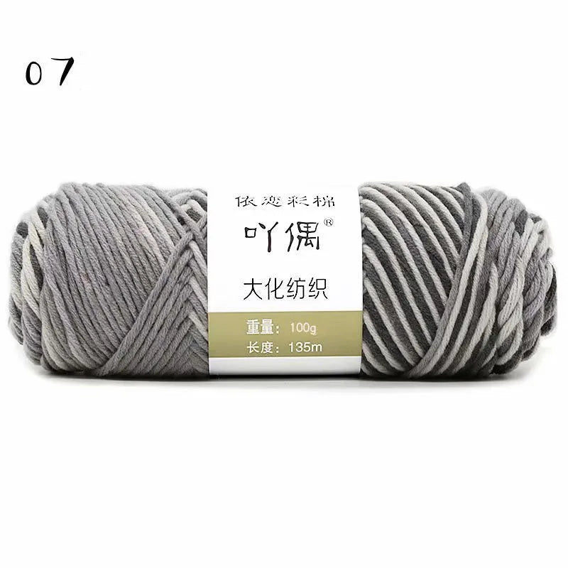 Eight strands of gradient milk cotton wool in a ball, showing multiple colour options for hand knitting.