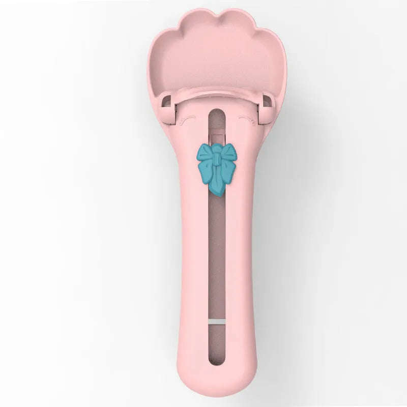 Green plastic pet food scoop with squeezer handle and dispensing nozzle for kibble and liquid.