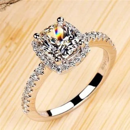 Women's silver colour alloy ring with artificial gemstone inlay and geometric design, bridal style.