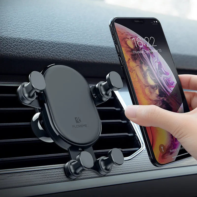 Black gravity car phone holder mounted on a car air vent, showing 360-degree rotation.