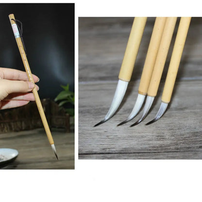 Four traditional writing brushes with gold bodies, wolf wool hair, and pine branch colour